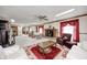 Open concept carpeted living room featuring a fireplace, ceiling fans and lots of natural light at 3360 E Main St, Danville, IN 46122
