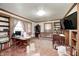 Cozy living room features wood trim, built-in shelving, vintage sofa, and a large window for natural light at 3360 E Main St, Danville, IN 46122