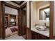 Half bathroom with a modern vessel sink, decorative mirror, and wood trim at 3360 E Main St, Danville, IN 46122