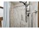Updated shower featuring a modern shower head, safety bar, and sleek marble-look walls at 3360 E Main St, Danville, IN 46122