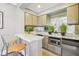 Bar featuring granite countertop, stainless appliances, decorative mirror, and seating at 355 E Ohio St # 309, Indianapolis, IN 46204