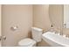 Cozy half bathroom features modern fixtures and a pedestal sink at 355 E Ohio St # 309, Indianapolis, IN 46204