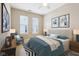 Comfortable bedroom featuring a plush bed, soft lighting, decor, and windows that allow natural light into the room at 355 E Ohio St # 309, Indianapolis, IN 46204