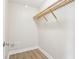 Walk-in closet featuring wooden shelving and laminate flooring at 355 E Ohio St # 309, Indianapolis, IN 46204