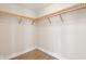 Walk-in closet featuring wooden wrap around shelving and laminate flooring at 355 E Ohio St # 309, Indianapolis, IN 46204