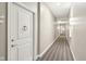 Hallway with beige carpet and walls, decorative lighting, and view of unit door at 355 E Ohio St # 309, Indianapolis, IN 46204