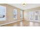 Bright, airy living room with wood floors, natural light, and access to patio at 355 E Ohio St # 309, Indianapolis, IN 46204
