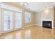Living room with fireplace and view of a balcony with white doors and windows at 355 E Ohio St # 309, Indianapolis, IN 46204