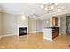 Living room with hardwood floors, fireplace, and a view of the kitchen area at 355 E Ohio St # 309, Indianapolis, IN 46204