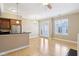 Open-concept living room with hardwood floors, kitchen and a view of a balcony at 355 E Ohio St # 309, Indianapolis, IN 46204