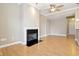 Living room with wood floors, black fireplace, ceiling fan, and light colored walls at 355 E Ohio St # 309, Indianapolis, IN 46204
