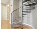 Close-up of a modern spiral staircase with carpeted steps and metal railings at 355 E Ohio St # 309, Indianapolis, IN 46204