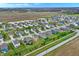 Panoramic aerial view of a community with a mix of housing styles and green spaces at 371 Bluestem Ln, Whiteland, IN 46184