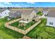 Aerial view of home showing large, fenced backyard with patio and fire pit in a Gathering-friendly neighborhood at 371 Bluestem Ln, Whiteland, IN 46184