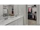 Bathroom featuring double sinks with white cabinetry, quartz countertop, and walk-in closet with ample storage at 371 Bluestem Ln, Whiteland, IN 46184