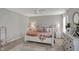 Cozy bedroom with a white bed frame, two side tables, neutral decor and plush carpeting at 371 Bluestem Ln, Whiteland, IN 46184