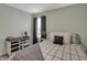 Bedroom features a comfortable bed with gray accents, a side table, and a window for natural light at 371 Bluestem Ln, Whiteland, IN 46184