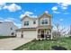 Charming two-story home featuring a spacious three-car garage and manicured lawn at 371 Bluestem Ln, Whiteland, IN 46184