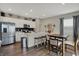 Open concept kitchen and breakfast nook with a large island, stainless appliances, and white cabinets at 371 Bluestem Ln, Whiteland, IN 46184