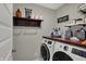 Well-organized laundry room featuring a front load washer and dryer, and ample storage space at 371 Bluestem Ln, Whiteland, IN 46184