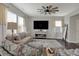 Comfortable living room features neutral tones, lots of natural light, and a unique ceiling fan at 371 Bluestem Ln, Whiteland, IN 46184