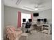 Well-lit office space featuring a large desk and multiple computer monitors, plus comfortable seating at 371 Bluestem Ln, Whiteland, IN 46184
