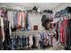 Well-organized walk-in closet with multiple rods, shelves, and storage for clothing, hats, and shoes at 371 Bluestem Ln, Whiteland, IN 46184
