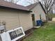 Exterior of home with blue trash receptacle, green back door, and white door laying on the ground at 3817 Cologne Ct, Indianapolis, IN 46228