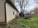 Exterior of home with small deck, grill, green grass and a cloudy sky at 3817 Cologne Ct, Indianapolis, IN 46228