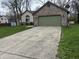 Large concrete driveway leading to an attached two-car garage at 3817 Cologne Ct, Indianapolis, IN 46228