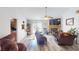 Comfortable living room features wood-look flooring, natural light, and fireplace at 3817 Cologne Ct, Indianapolis, IN 46228