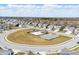 Aerial view showcasing neighborhood amenities like a playground, pool, and parking area at 3999 Kensington Dr, Danville, IN 46122