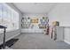 Large, empty room with neutral carpet, a built-in shelving unit, and a bright window view at 3999 Kensington Dr, Danville, IN 46122