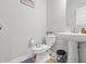 Bright bathroom features a toilet with fun decals, plus a pedestal sink with a chrome faucet and matching accessories at 3999 Kensington Dr, Danville, IN 46122