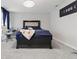 Comfortable bedroom with padded headboard, carpet, and a modern ceiling fan at 3999 Kensington Dr, Danville, IN 46122