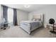 Modern bedroom featuring padded headboard, carpeting, and large window at 3999 Kensington Dr, Danville, IN 46122