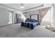 Bright bedroom with tray ceiling, carpet, large windows and gray furniture at 3999 Kensington Dr, Danville, IN 46122