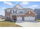 Charming two-story home with brick and siding exterior, a two-car garage, and well-manicured front yard at 3999 Kensington Dr, Danville, IN 46122