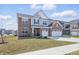 Two-story home featuring a two-car garage, a manicured lawn, and welcoming front entrance at 3999 Kensington Dr, Danville, IN 46122