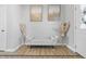 An interior decor with cream bench seating, wood laminate flooring, and decorative dried floral arrangements at 3999 Kensington Dr, Danville, IN 46122