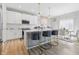 Modern kitchen with white cabinets, stainless steel appliances, and island seating for three at 3999 Kensington Dr, Danville, IN 46122