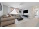 Spacious living room boasts plush seating, modern fan, and large TV at 3999 Kensington Dr, Danville, IN 46122