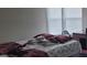Bedroom showing the bed and its patterned bedding, a window, and a desk at 4063 Orchard Valley Blvd, Indianapolis, IN 46235