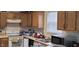 Functional kitchen with appliances and wooden cabinets ready for culinary adventures at 4063 Orchard Valley Blvd, Indianapolis, IN 46235