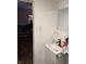 Small bathroom featuring a simple vanity sink and view to the bedroom at 408 N Colorado Ave, Indianapolis, IN 46201