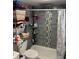 Bathroom featuring shower with gray tile and functional shelving unit at 408 N Colorado Ave, Indianapolis, IN 46201