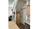 Hallway area beneath a staircase with a wooden storage door at 408 N Colorado Ave, Indianapolis, IN 46201