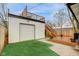 Backyard featuring a deck, garage, and small grass patch at 415 S Oxford St, Indianapolis, IN 46201