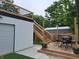 Wooden deck featuring outdoor seating, a dining area, and access stairs, ideal for entertaining and enjoying the outdoors at 415 S Oxford St, Indianapolis, IN 46201