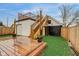 Exterior view of a wooden deck, garage, and artifical grass in the backyard at 415 S Oxford St, Indianapolis, IN 46201